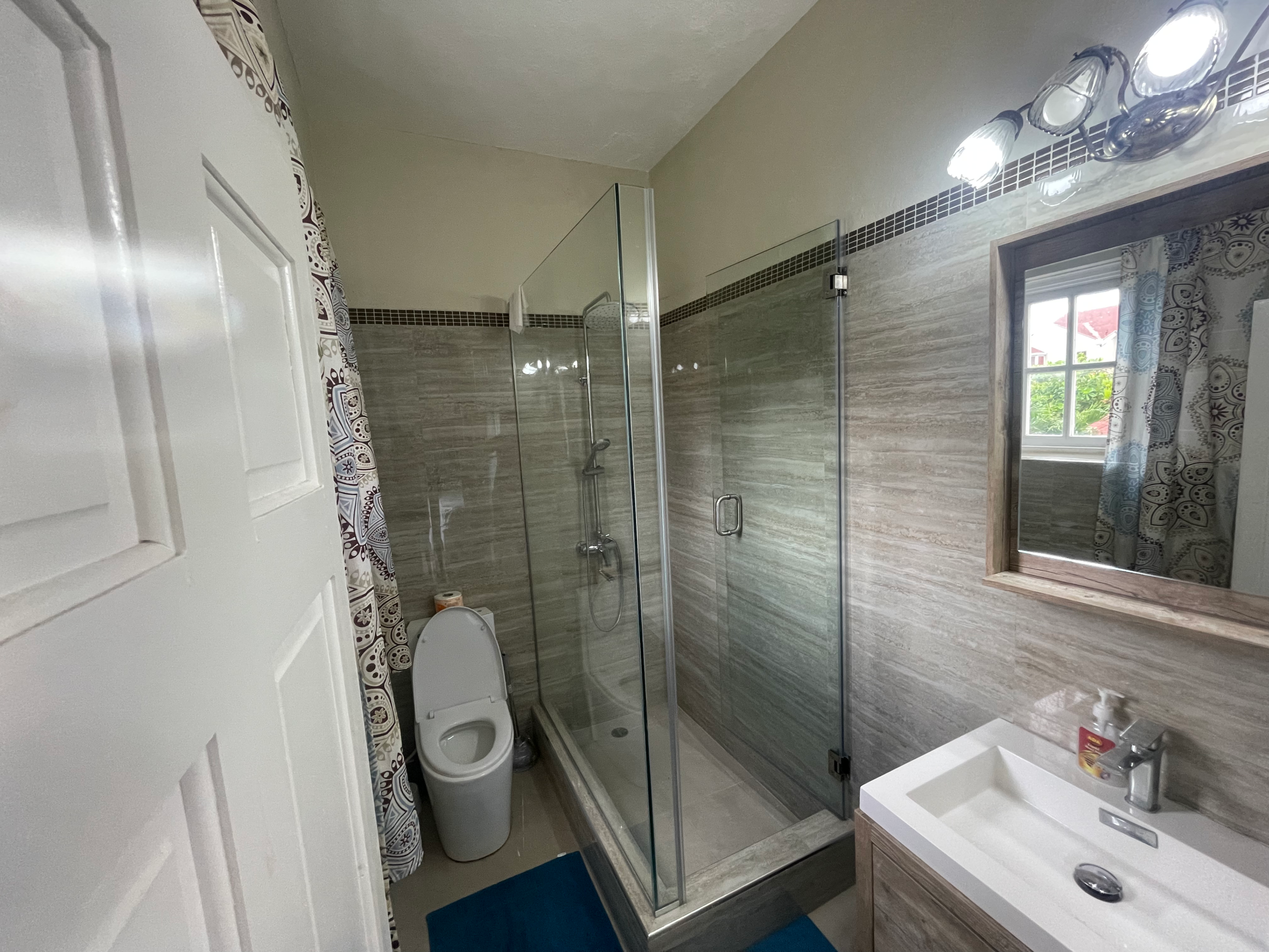 Modern bathroom with walk-in shower at Ochi50 apartment in Ocho Rios